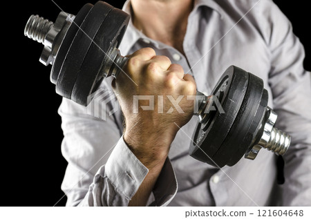 Closeup of businessman lifting weights 121604648