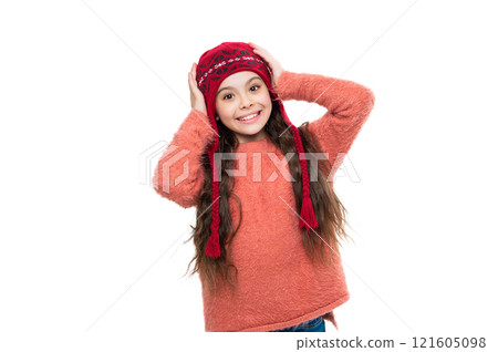 Stylish girl in winter hat. Teen child portrait wearing warm winter hat. Girl kid isolated on white. Happy childhood. Teen girl wearing knitted sweater. Winter fashion style. Winter inspired fashion 121605098