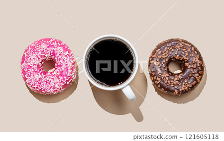 Flat lay of espresso coffee cup and fresh donuts on beige background with shadow. 121605118