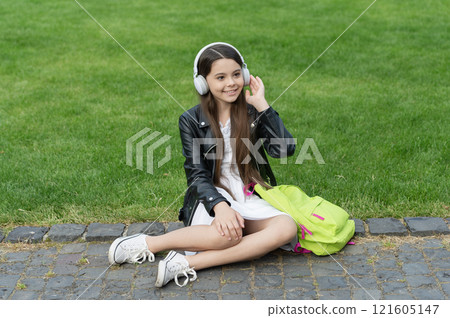 Listen to music in headphones. Stylish girl generation listen audio. Lifestyle concept. Back to school. School education. Teen girl school student listen music outdoor. Modern lifestyle. Student life Listen to music in headphones. Stylish girl generation listen audio. Lifestyle concept. Back to school. School education. Teen girl school student listen music outdoor. Modern lifestyle. Student life 121605147