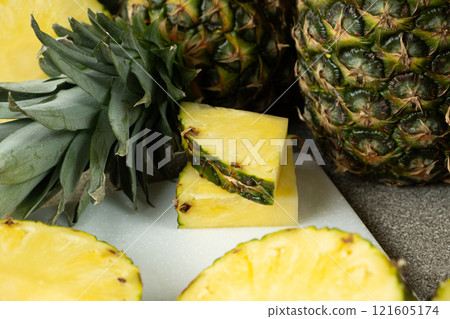 Pineapple background - whole fruit pineapples and cut into pieces and rings. 121605174