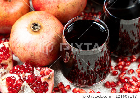 Pomegranate juice poured into two glasses, close-up. Pomegranate juice poured into two glasses, close-up. 121605188