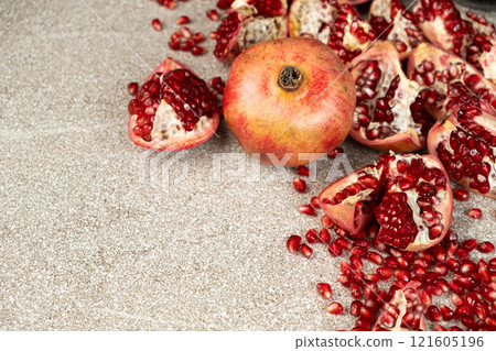 Ripe pomegranates, peeled and whole, place for text Ripe pomegranates, peeled and whole, place for text 121605196