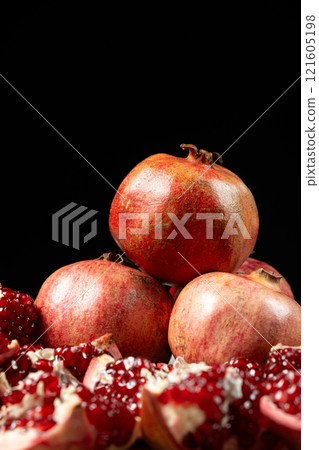 Ripe pomegranates, peeled and whole, the concept of benefits and vitamins in fruit. 121605198