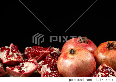 Ripe pomegranates, peeled and whole, place for text Ripe pomegranates, peeled and whole, place for text 121605203