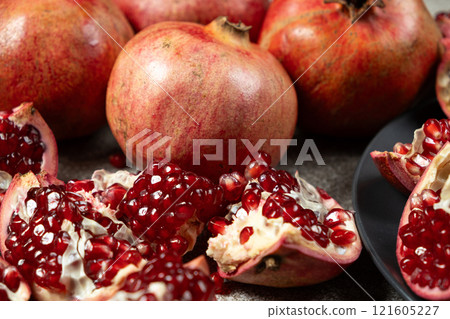 Ripe pomegranates, peeled and whole, the concept of benefits and vitamins in fruit. Ripe pomegranates, peeled and whole, the concept of benefits and vitamins in fruit. 121605227