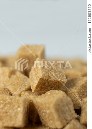 Macro cubes of brown cane unrefined demerara sugar. 121605230