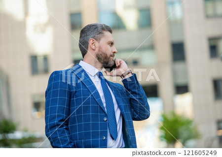 Businessman talking on phone. Businessman in front office. Social network. Hispanic business man with phone at office building. Businessman using phone. Man phone conversation in city. Job interview 121605249