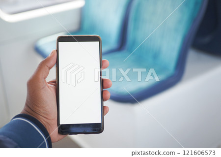 young man hand using smart phone with green screen inside of metro train 121606573