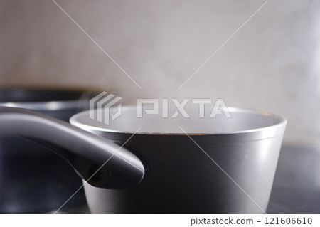 steam rising from saucepan closeup steam rising from saucepan closeup 121606610