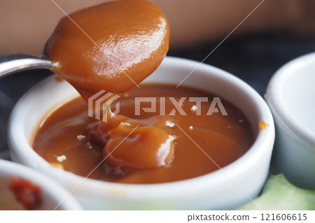 Delicious Caramel Sauce Served in an Elegant Small Serving Dish for You 121606615