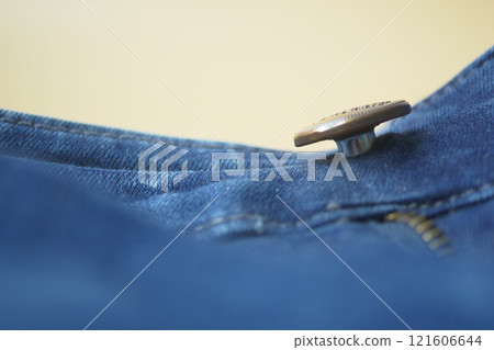 A Detailed CloseUp View of a Button and Zipper on Denim Jeans A Detailed CloseUp View of a Button and Zipper on Denim Jeans 121606644