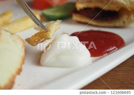 A delectable breakfast plate featuring a variety of tasty dipping sauces 121606695