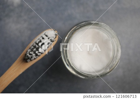 A bowl of baking soda, a bamboo toothbrush, A bowl of baking soda, a bamboo toothbrush, 121606713