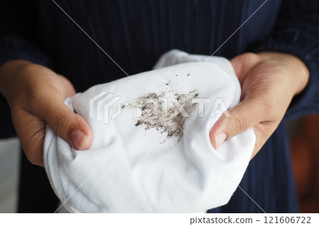 women holding white color dirty shirt, showing making stain women holding white color dirty shirt, showing making stain 121606722