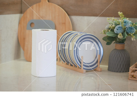 Simple Kitchen Countertop With White Roll, Dish Rack, and Floral Display Simple Kitchen Countertop With White Roll, Dish Rack, and Floral Display 121606741