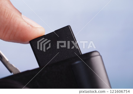 putting SD memory card in a camera putting SD memory card in a camera 121606754