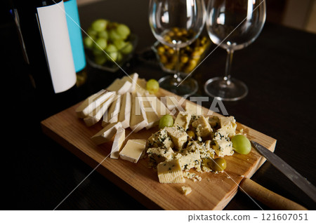 Cheese Platter with Grapes and Wine on a Wooden Table 121607051