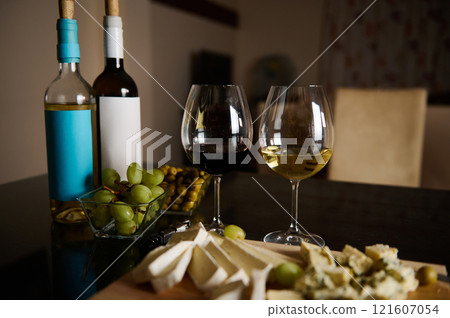 Elegant wine tasting setting with assorted cheeses and fresh grapes 121607054