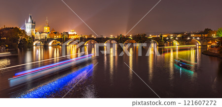 Vltava River with boat neon light lines and Charles Bridge with Old Town Bridge Tower by night, Prague, Czechia. UNESCO World Heritage Site. Vltava River with boat neon light lines and Charles Bridge with Old Town Bridge Tower by night, Prague, Czechia. UNESCO World Heritage Site. 121607272