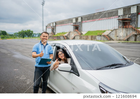 Joyful People Enjoying and Celebrating a Successful and Fun Driving Experience Together 121608694