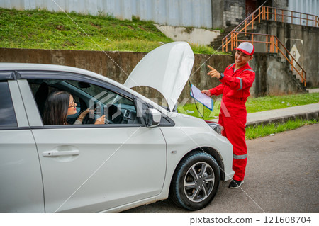 Car Breakdown Assistance A Mechanic is Helping a Driver in Distress Situations Car Breakdown Assistance A Mechanic is Helping a Driver in Distress Situations 121608704