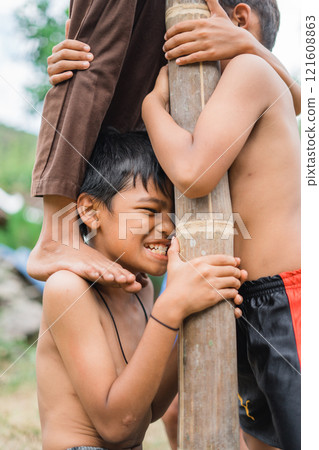 children bear the weight of friends climbing on their shoulders 121608863