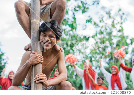 man laughs while bearing the weight of climbing the areca nut man laughs while bearing the weight of climbing the areca nut 121608870
