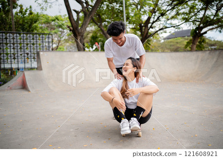 Joyful Moments at a Skate Park Playful Friends Enjoying Fun Together in the Sun 121608921