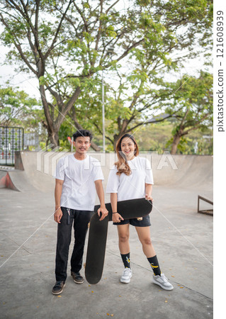 Skateboarding Enthusiasts are Fully Enjoying a Beautiful, Sunny Day at the Park 121608939