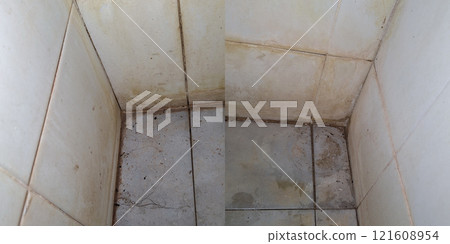 Accumulated dirt on the walls and floor in the bathroom. 121608954
