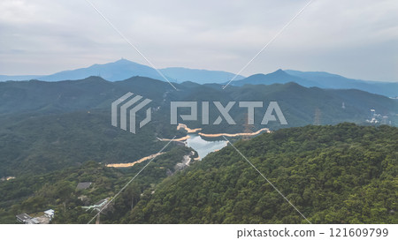 View of Lush Forested Mountains and Serene Reservoir Dec 24 2024 121609799