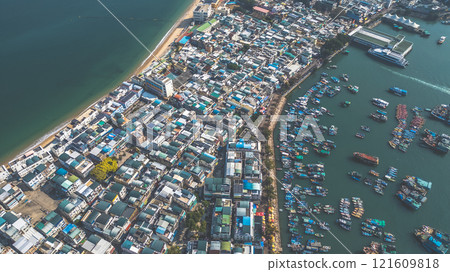 Dec 28 2022 Coastal City and Fishing Boats in a Harbor Dec 28 2022 Coastal City and Fishing Boats in a Harbor 121609818