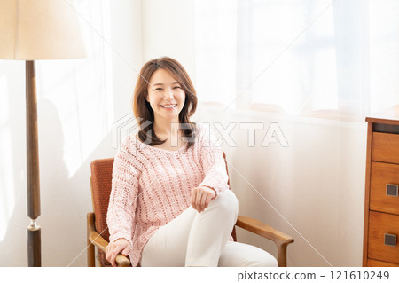 A young woman relaxing in the room A young woman relaxing in the room 121610249