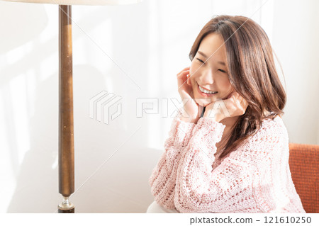 A young woman relaxing in the room A young woman relaxing in the room 121610250