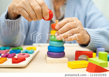 Alzheimer disease AD, Asian elderly woman patient suffering from dementia learn practical motor skills rehabilitation. 121610269