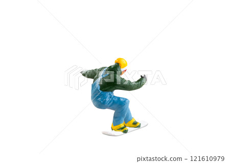 Miniature figurine depicting a snowboarder in mid-motion isolate on white background with clipping path 121610979