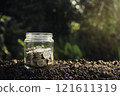 Coins in glass for business and tax season on a blur background. 121611319