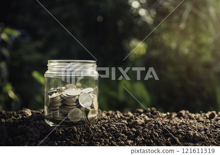 Coins in glass for business and tax season on a blur background. Coins in glass for business and tax season on a blur background. 121611319