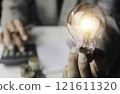 Business accounting with saving money with light bulb concept financial. 121611320