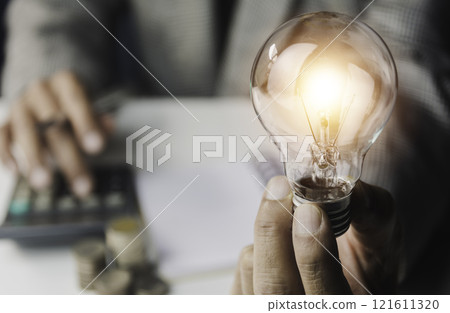 Business accounting with saving money with light bulb concept financial. Business accounting with saving money with light bulb concept financial. 121611320