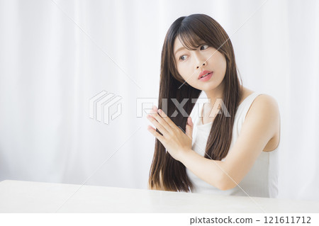 Young woman taking care of her hair 121611712