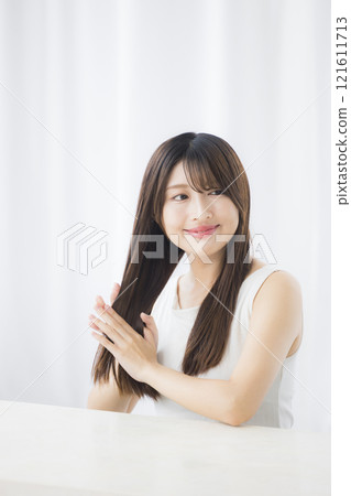 Young woman taking care of her hair 121611713