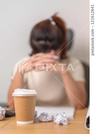 Coffee disposable cup against woman having Tired and Stressed while working, female businesswoman having headache and Migraine at office or Home late night. Overworked and Overtime Coffee disposable cup against woman having Tired and Stressed while working, female businesswoman having headache and Migraine at office or Home late night. Overworked and Overtime 121612641