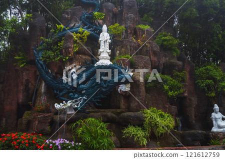 A statue of a dragon and a Buddha standing on it A statue of a dragon and a Buddha standing on it 121612759