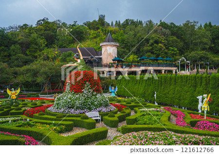 A beautiful blooming garden with flower sculptures paths and hedges on a sunny clear day A beautiful blooming garden with flower sculptures paths and hedges on a sunny clear day 121612766