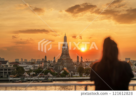 Wat Arun Temple in sunset, Tourists enjoy the view to Temple of Dawn near Chao Phraya river. Take photo from rooftop bar. Landmark and Travel destination in Bangkok, Thailand and Southeast Asia 121612828