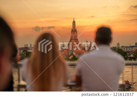 Wat Arun Temple in sunset, Tourists enjoy the view to Temple of Dawn near Chao Phraya river. Take photo from rooftop bar. Landmark and Travel destination in Bangkok, Thailand and Southeast Asia 121612837