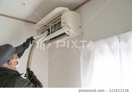 House cleaning male worker cleaning the air conditioner 121613136