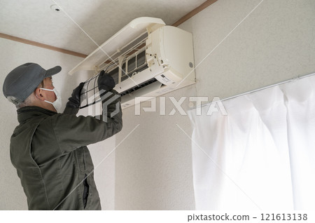 House cleaning male worker cleaning the air conditioner 121613138